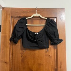 Black Crop Top. Metal pieces in front. New with tags.